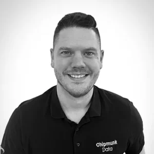 Comp Cloud – About Us7 Professional headshot of smiling man wearing Chipmunk Data polo shirt