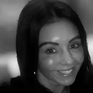 Comp Cloud – About Us8 Black and white portrait of smiling woman with long dark hair