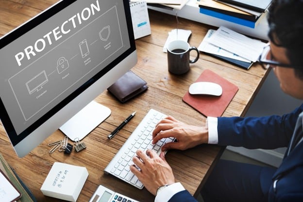 Professional using computer displaying cybersecurity protection interface